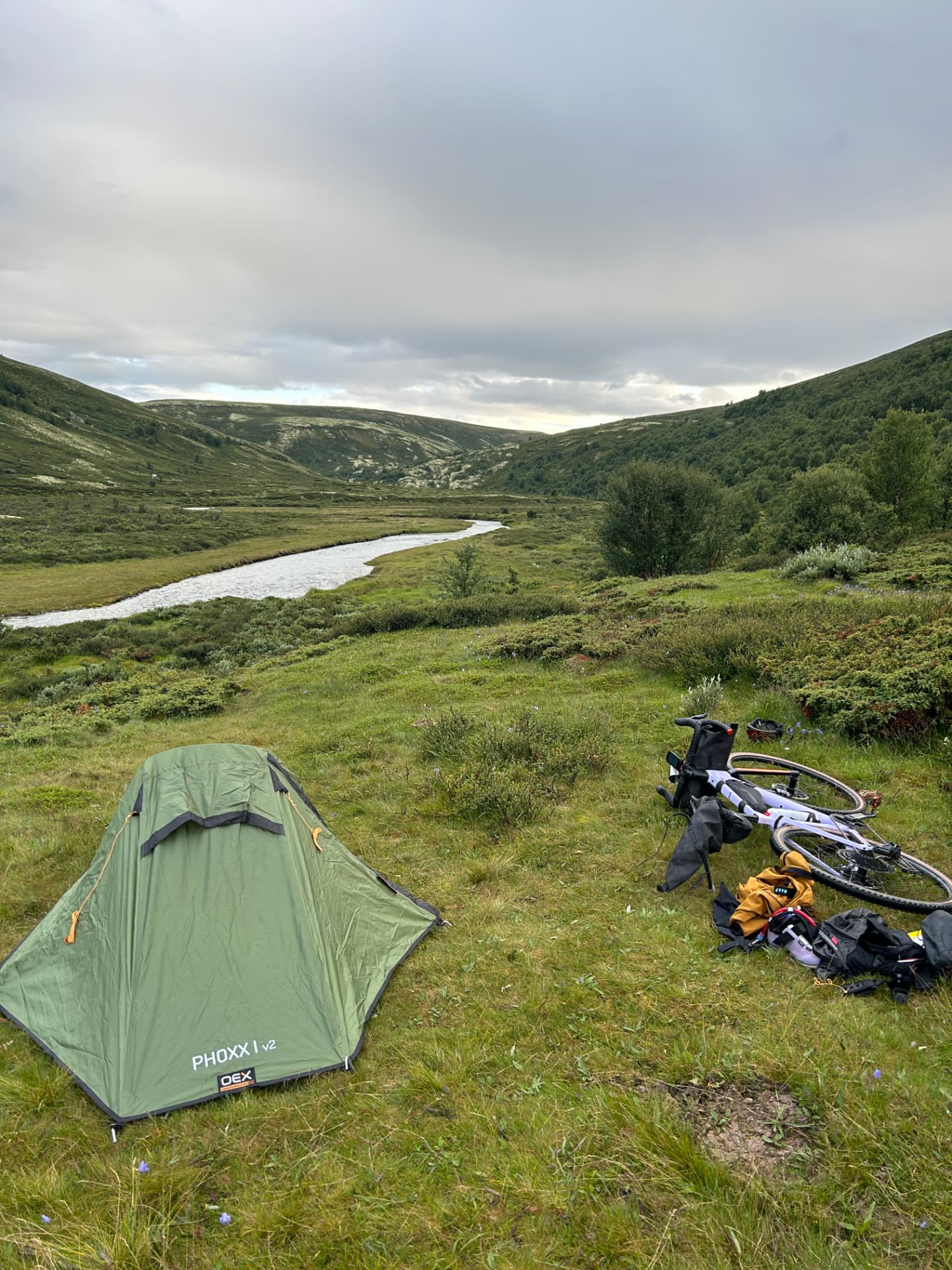 A bikepacking camp beside a mountain river